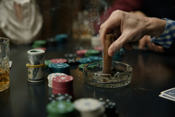 Man Putting Out Cigar During Intense Poker Game