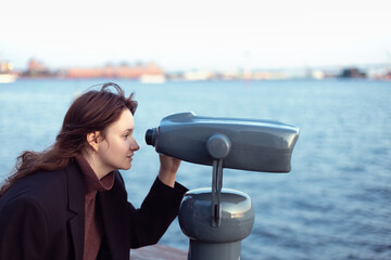Tourist on the observation deck,  woman using Tower viewer, local budget travel