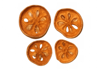 Dried bael fruit slices revealing inner seeds, displaying rough texture against transparent backdrop