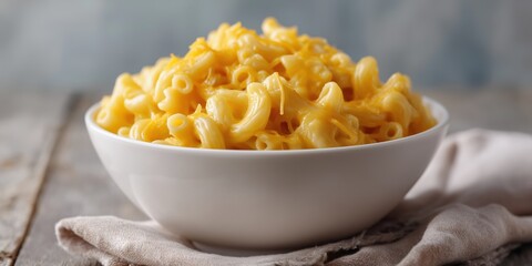 Creamy macaroni and cheese in a white bowl on wooden table