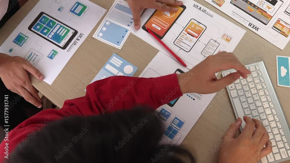 Poster top view panorama video of startup company employee planning on user interface prototype for mobile 