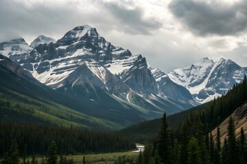 Obraz premium Snow-Capped Mountains and Evergreen Forest Beneath Dramatic Cloudscape