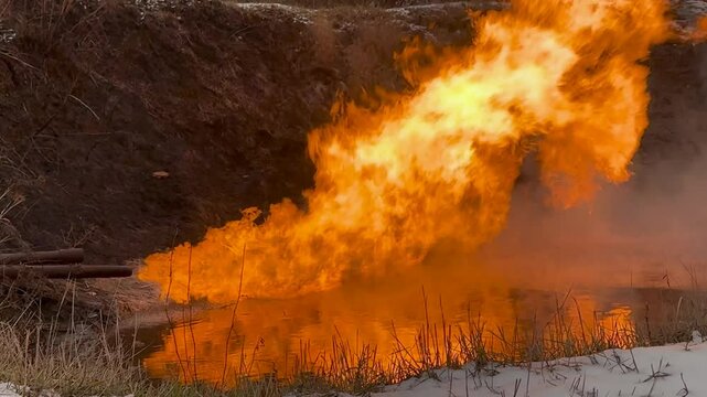 Ukraine, Shebelinka gas field engineers release and ignite problematic gas and gas condensate in a special barn for safety during a snowfall in winter