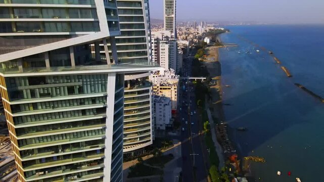View from above on Limassol buildings, evening Cyprus
High-rise towers of Cyprus. Summer sunset and Mediterranean sea with city traffic in the background