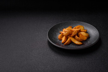 Grilled potato wedges with rosemary, cheese, salt and spices. Baked potato slices