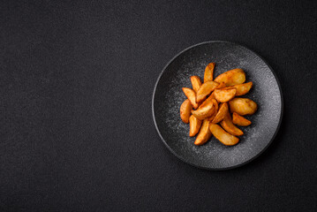 Grilled potato wedges with rosemary, cheese, salt and spices. Baked potato slices