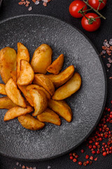 Grilled potato wedges with rosemary, cheese, salt and spices. Baked potato slices