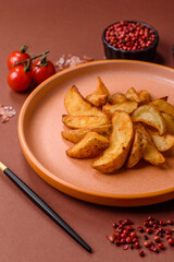 Grilled potato wedges with rosemary, cheese, salt and spices. Baked potato slices