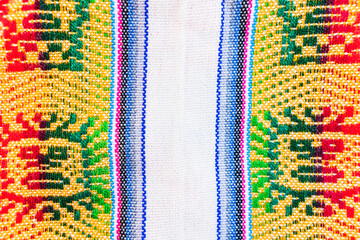 Colorful hand-woven Inca textile background with ancient designs from the Andes mountain range of...