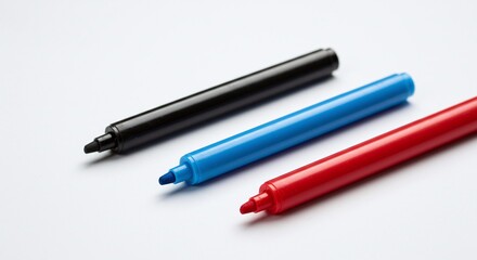 Black Blue and Red Marker Pens on White Surface