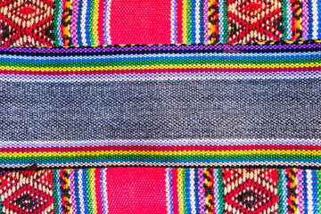 Colorful hand-woven Inca textile background with ancient designs from the Andes mountain range of...
