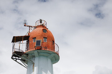 Aged Coastal Lighthouse with Blue Sky