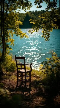 Empty Wooden Chair by Sparkling Lake in Summer Forest