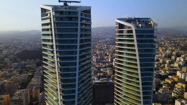 View from above on Limassol buildings, evening Cyprus
High-rise towers of Cyprus. Summer sunset and Mediterranean sea with city traffic in the background