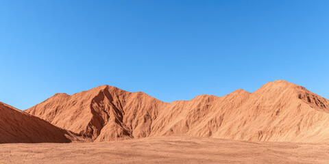 Naklejka premium Sand dunes rise against a clear blue sky, creating a serene desert landscape. Desert, nature, dunes, blue sky, tranquility, arid, wilderness, simplicity