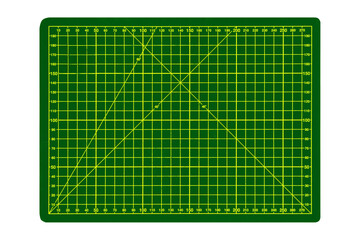 Medium green cutting mat with yellow grid and angular markings is isolated.