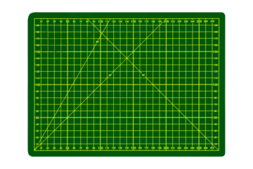 Medium green cutting mat with yellow grid and angular markings is isolated.