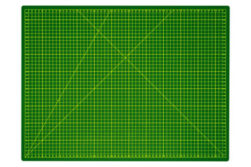 Large green cutting mat with yellow grid and measurement markings is isolated.