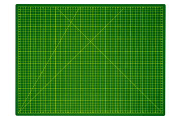 Large green cutting mat with yellow grid and measurement markings is isolated.