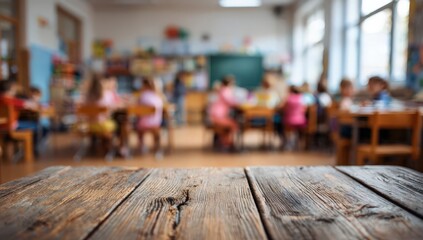 Blurred elementary school classroom with children at desks playing, wooden table in foreground. Concept for learning, teaching, and educational themes with space for text or product display.