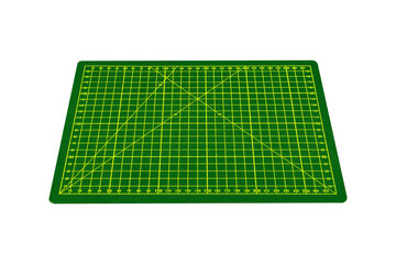 Small green cutting mat with yellow grid and angle markings is isolated.