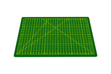 Small green cutting mat with yellow grid and angle markings is isolated.