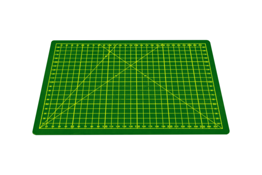 Small green cutting mat with yellow grid and angle markings is isolated.