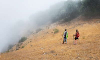 Foggy Morning Hike Through Mountains by Adventurous Couple