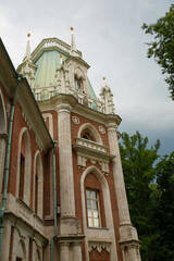 High roof view of the royal old palace in the park in Moscow city under with windows and arches on summer day blue sky. Closeup