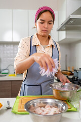 Young latin american chef adding red onion to peruvian ceviche recipe