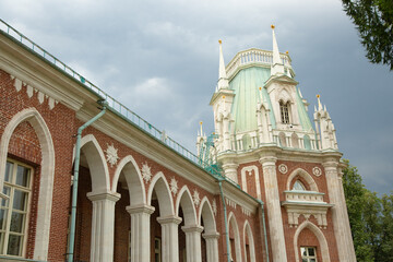 High roof view of the royal old palace in the park in Moscow city under with windows and arches on summer day blue sky. Closeup
