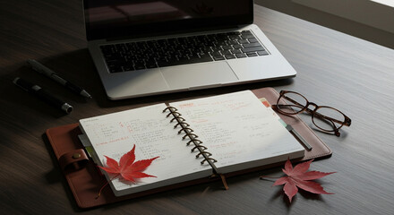 Autumn workspace with laptop, planner, and falling leaves  