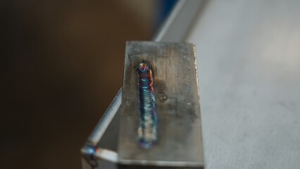 Colorful welding seam on a metal surface, created using specialized welding techniques