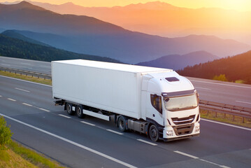 Modern Sustainable Efficient White Cargo Refrigeration Truck Driving Through Scenic Mountain...