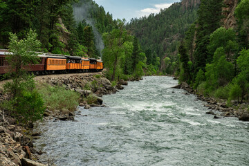 train trees mountain river blue sky