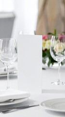 Elegant White Table Setting with Blank Card Glassware and Floral Centerpiece
