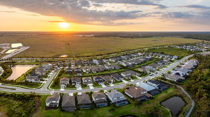 Gated community with expensive houses between green palm trees in southwest Florida. Premium...
