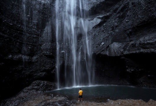 Rear view of a man standing by Tumpak Sewu Waterfall, East Java, Indonesia