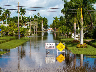 Street under water warning sign. Closed city road because of flooding blocking driving of cars....