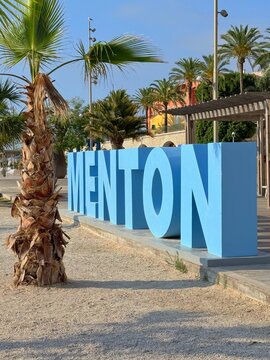 Giant city name in capital letters on the beach, Menton, Alpes-Maritimes, Provence-Alpes-Cote d'Azur, France