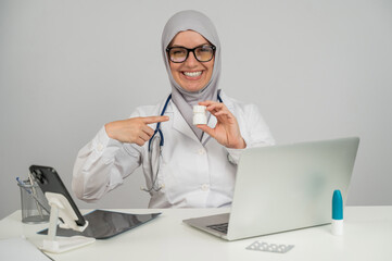 Female doctor in hijab recommends medications. 