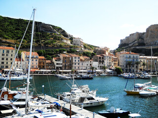 Scenic View of Bonifacio Port in Corsica with Luxury Yachts and Cliffside Town Experience the charm of the French island of Corsica with this stunning image capturing the picturesque port of Bonifacio
