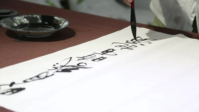 Arabic Calligraphy of &ldquo;Bismillah&rdquo; in Progress

Artist Drawing Bismillah with Traditional Qalam

Close-Up Islamic Calligraphy Art Creation