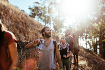 Young and diverse group of friends and hikers hiking together in the mountains of south africa