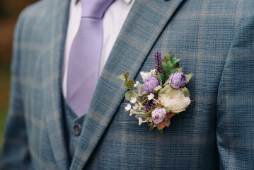 purple boutonniere on groom jacket