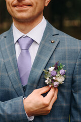 purple boutonniere on groom jacket