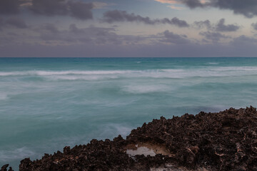 Sunset on the sandy beach of the Atlantic Ocean.