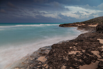 Sunset on the sandy beach of the Atlantic Ocean.