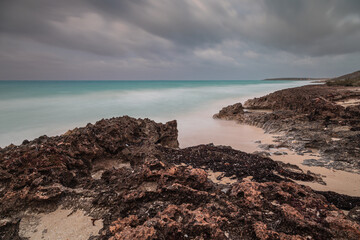 Sunset on the sandy beach of the Atlantic Ocean.