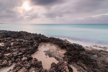 Sunset on the sandy beach of the Atlantic Ocean.